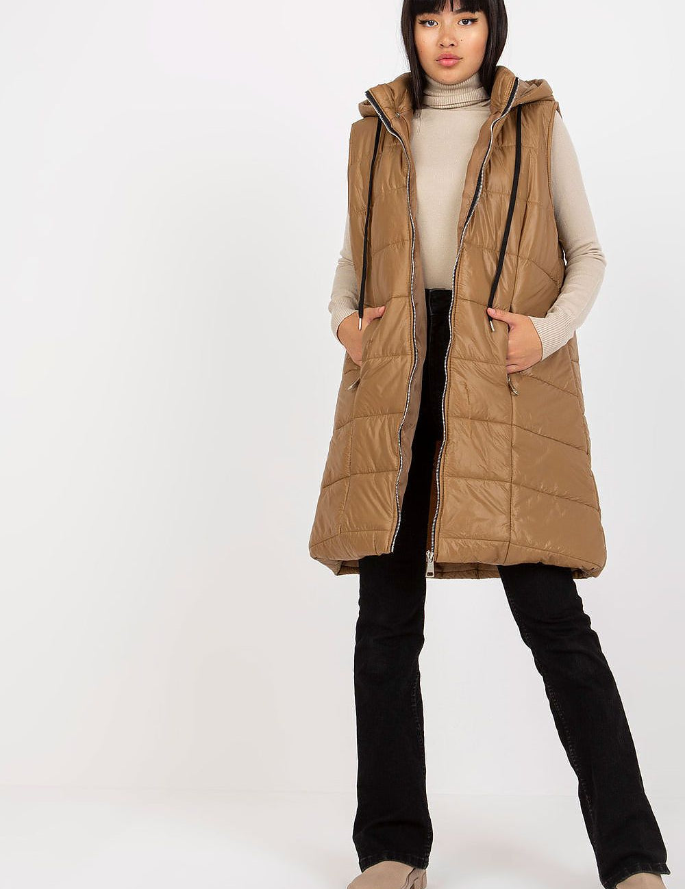Evrendelle Quilted Longline Vest with detachable hood and front zipper, shown on model, ideal for transitional weather layering.
