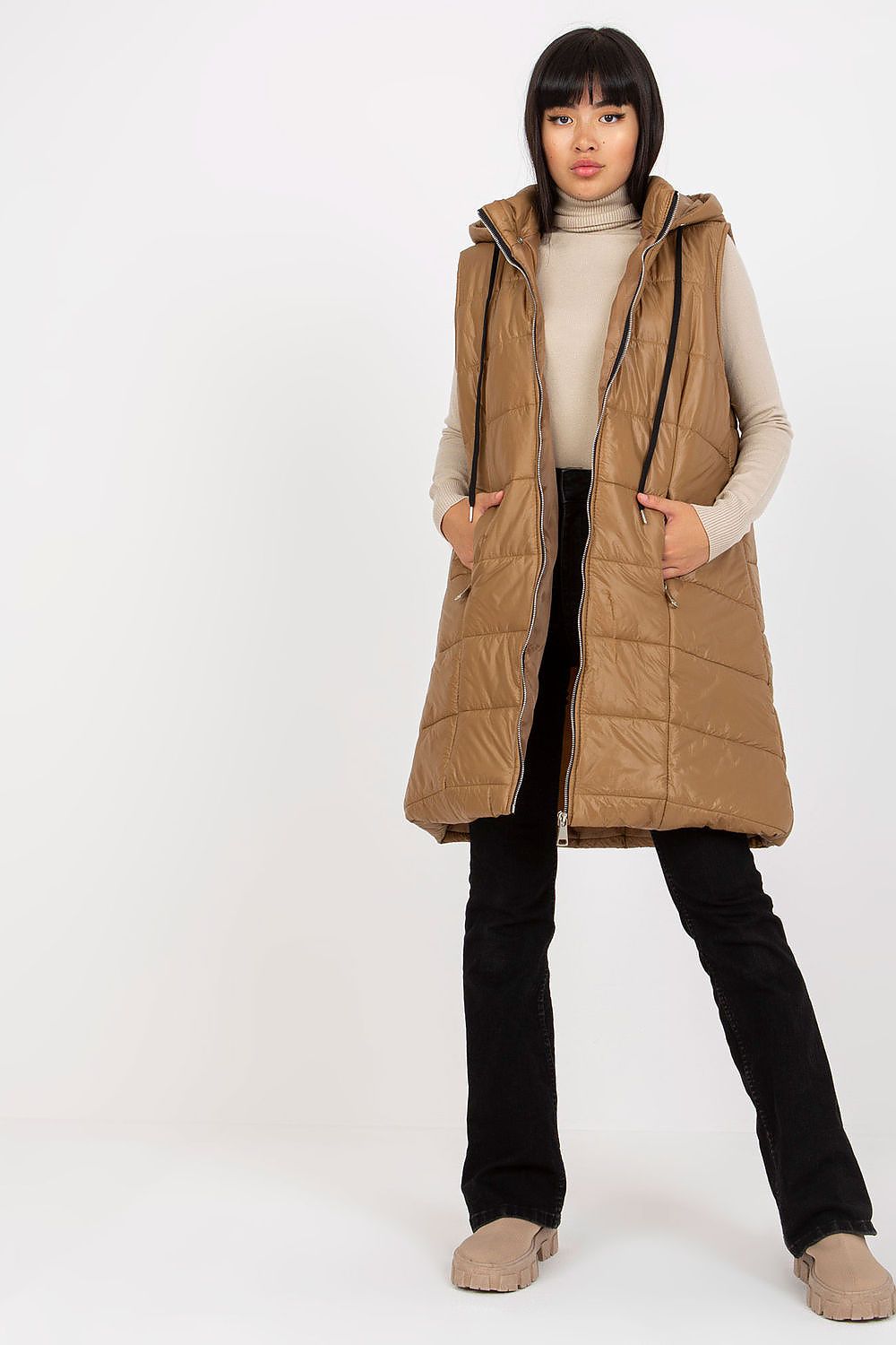 Evrendelle Quilted Longline Vest with detachable hood and front zipper, shown on model, ideal for transitional weather layering.