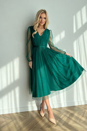 Model wearing green Marleia Mesh-Layered Evening Midi Dress with sheer sleeves and flared skirt.