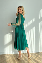Woman wearing Marleia Mesh-Layered Evening Midi Dress in green with sheer sleeves, showcasing the elegant layered skirt and unique back design.