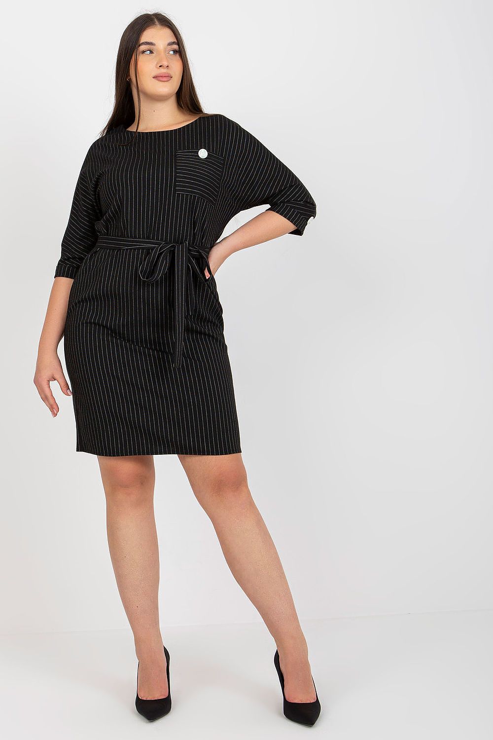 Plus size woman wearing Velmira striped pencil dress with tie belt and 3/4 sleeves, showcasing elegant and tailored style.