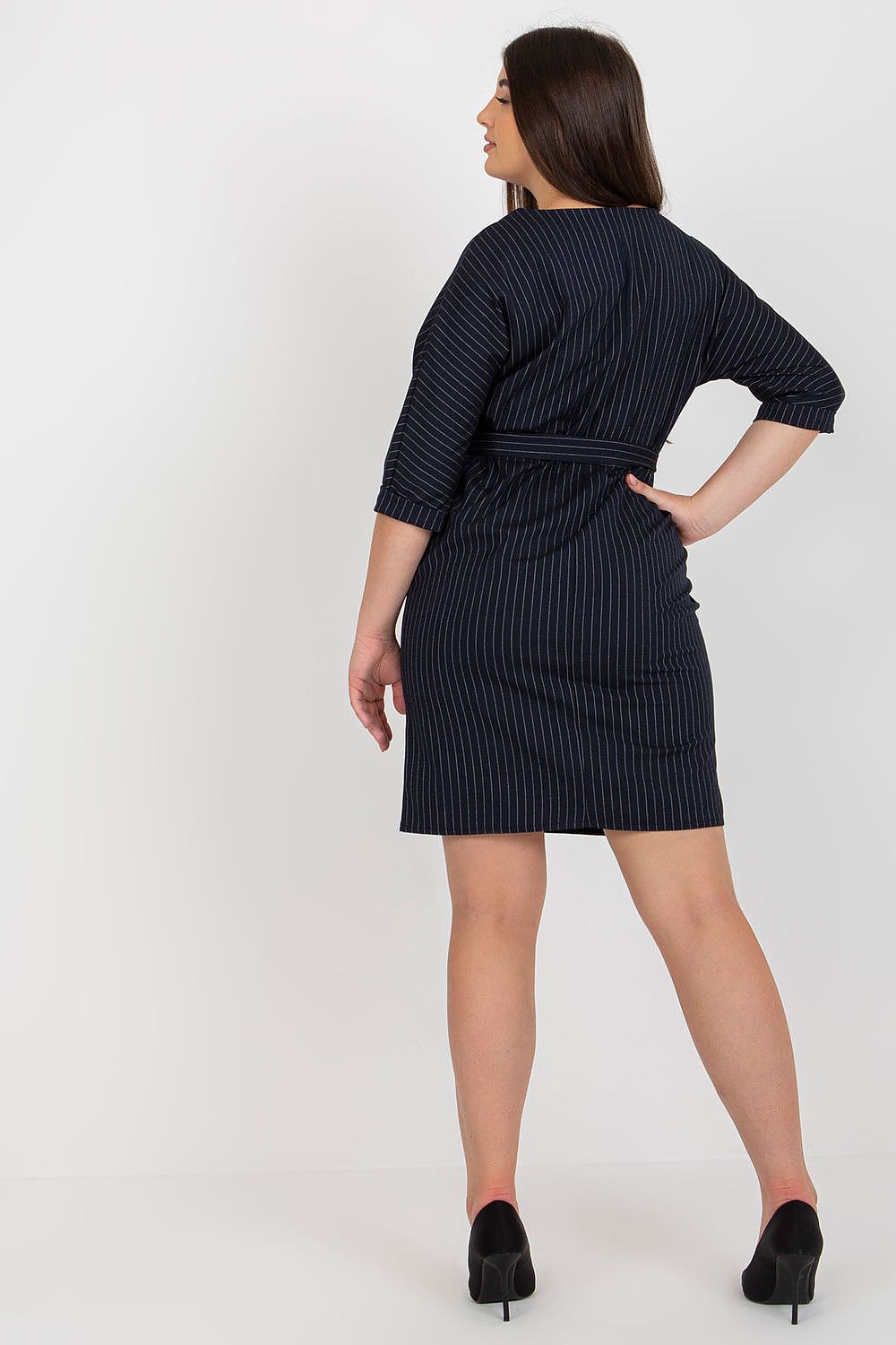 Back view of Velmira Plus Size Striped Pencil Dress with 3/4 sleeves and tie belt, showcasing elegant and flattering silhouette.