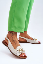 Dorellia Leather Flat Sandals with chain detail and adjustable ankle strap, worn with green pants for a stylish summer look.