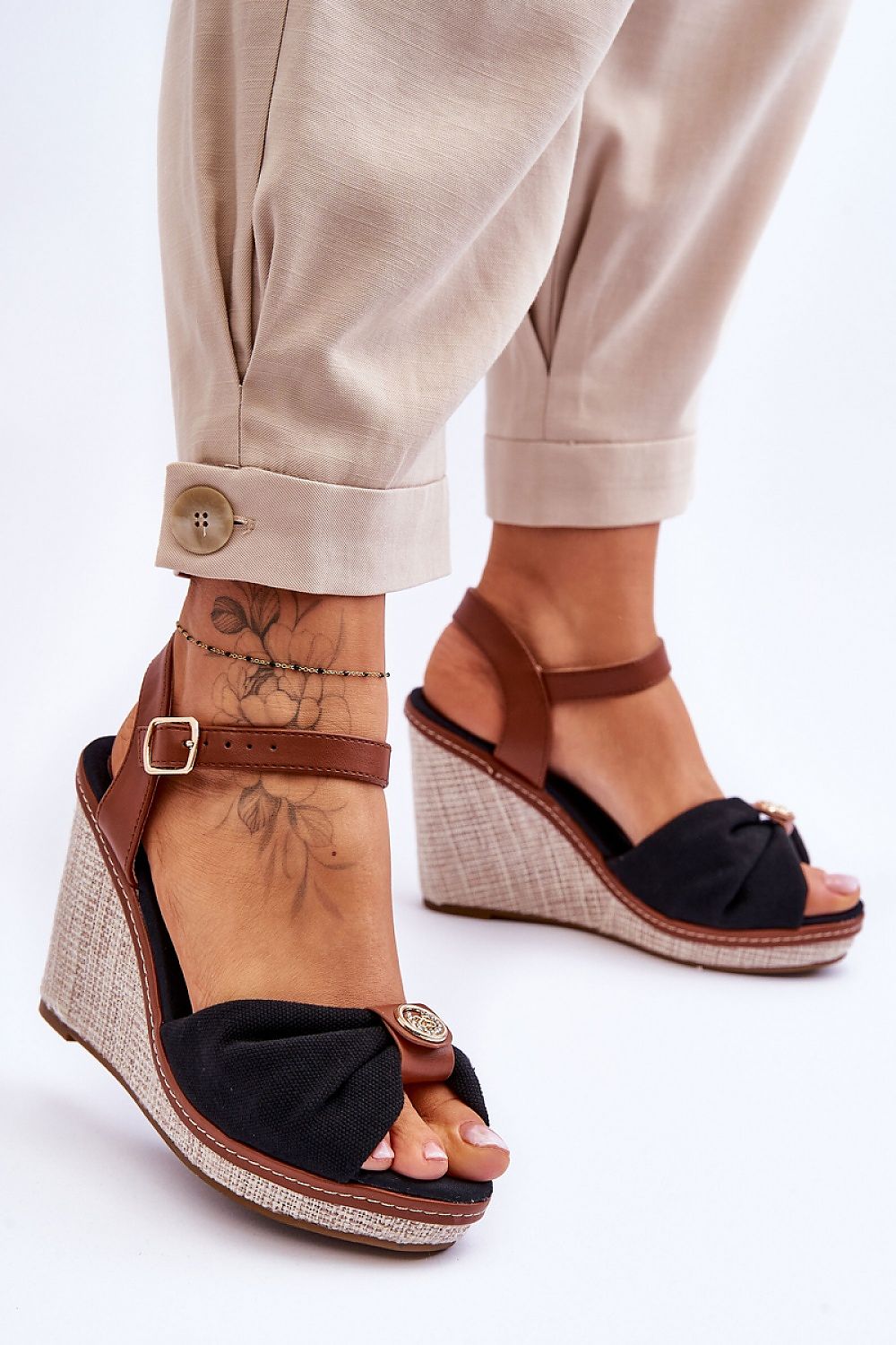 Woman wearing Arvola Rhinestone Platform Buskins with ankle strap, high heel and platform, featuring black textile and rhinestone detail.