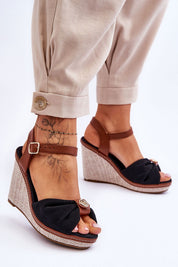 Woman wearing Arvola Rhinestone Platform Buskins with ankle strap, high heel and platform, featuring black textile and rhinestone detail.