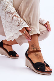 Woman wearing Larvella Woven Fabric Buskins with buckle strap, showcasing modern wedge sandals, perfect for warm-weather sophistication.