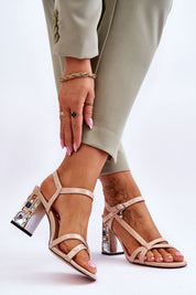 Woman wearing Carinea High Heel Sandals with strappy eco leather and stiletto heel, showcasing shimmering details and charm elegance.