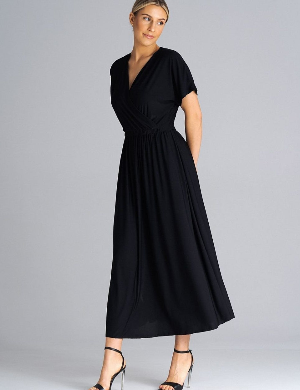 Woman wearing Ravelle Draped Slit Midi Dress with V-neckline, short sleeves, and side slits, perfect for casual or elegant events.
