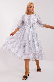 Plus Size Delmira Waist-Tie Midi Dress with 3/4 sleeves worn by model, showcasing elegant silhouette and customizable fit.