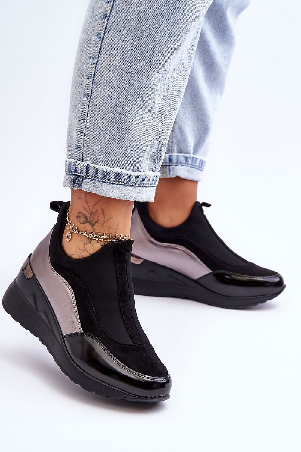 Lestora Dual-Layer Slip-On Sneakers with soft-touch fabric and eco-leather, offering elegance and comfort paired with denim jeans.