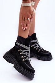 Black eco-suede chunky heel ankle boots with silver laces and a platform sole, perfect for winter fashion, shown on a model's feet.