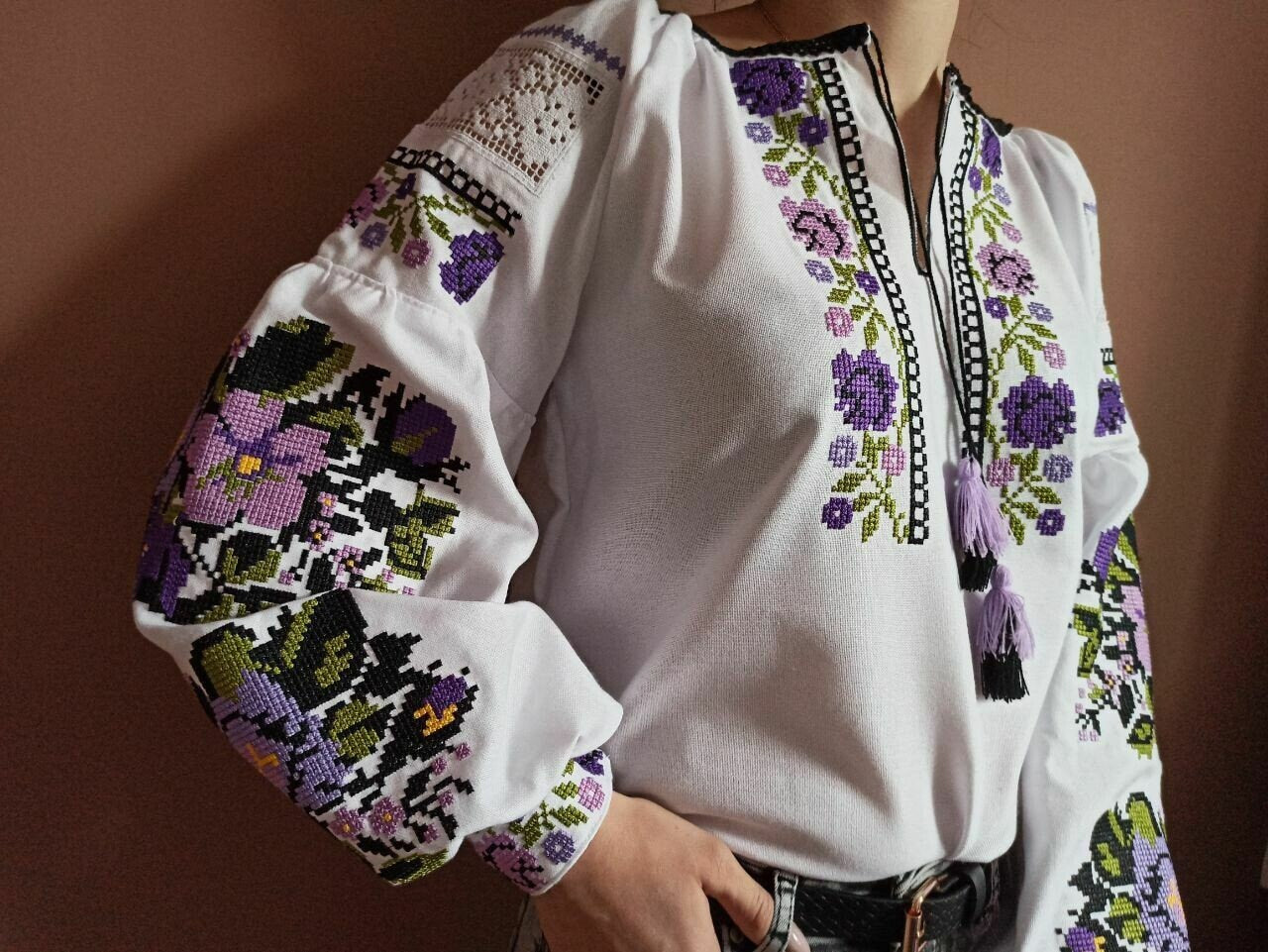 Ukrainian Vyshyvanka blouse with traditional purple floral embroidery on white homespun fabric for women.