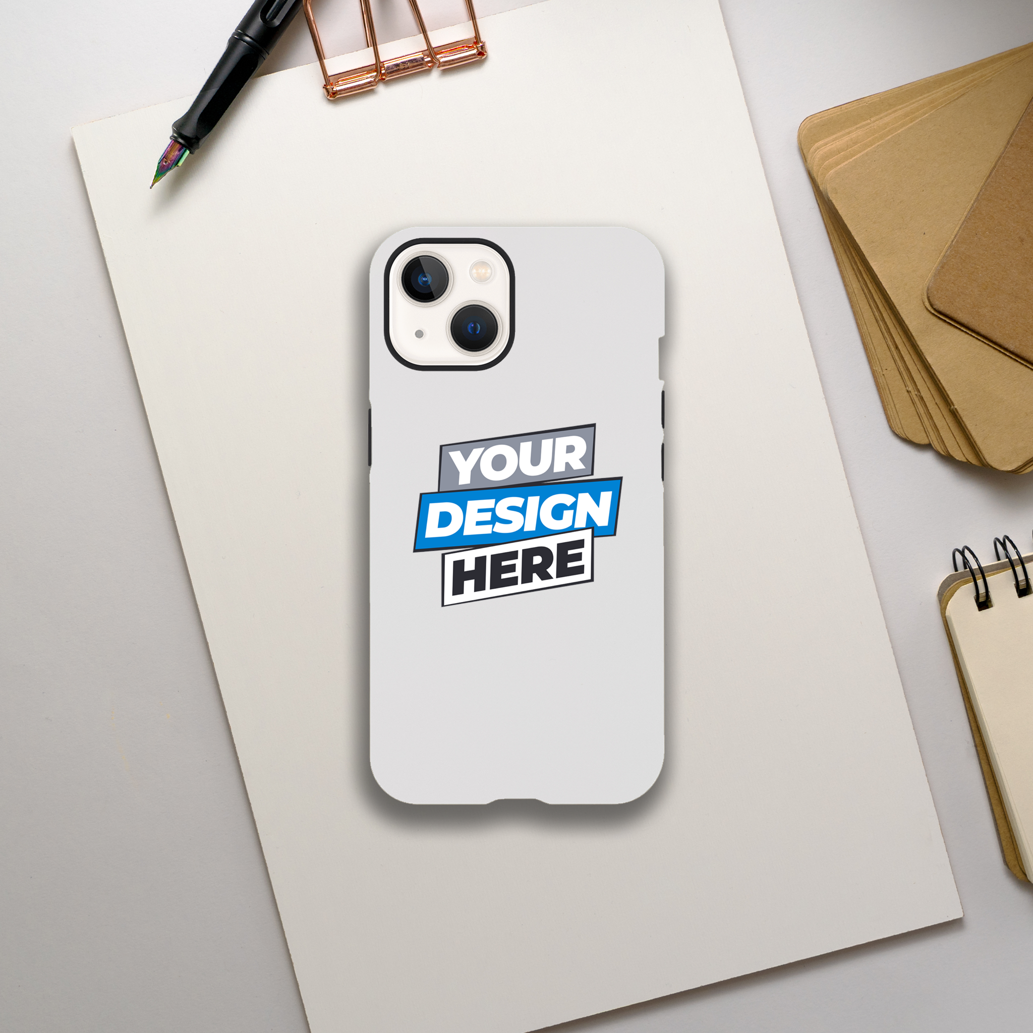 Alt Tag: Print on Demand Gloss Tough iPhone Case with dual-layer protection and customizable design on a desk with notepad and pen.