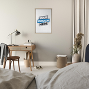 Minimalist bedroom with desk and framed canvas print design on wall, featuring neutral decor and elegant lighting.