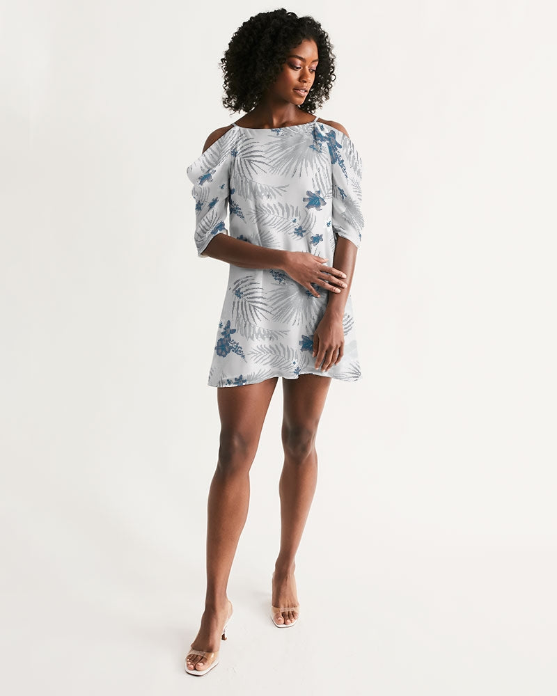Woman wearing Palm Soul open-shoulder A-line dress with island print and short flutter sleeves, barefoot on white background.
