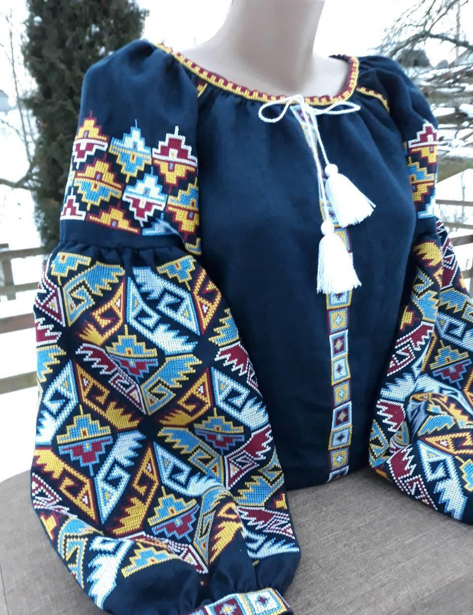 Dark blue Ukrainian Vyshyvanka blouse with colorful folk embroidery and tassels for women.