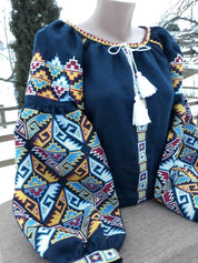 Dark blue Ukrainian Vyshyvanka blouse with colorful folk embroidery and tassels for women.