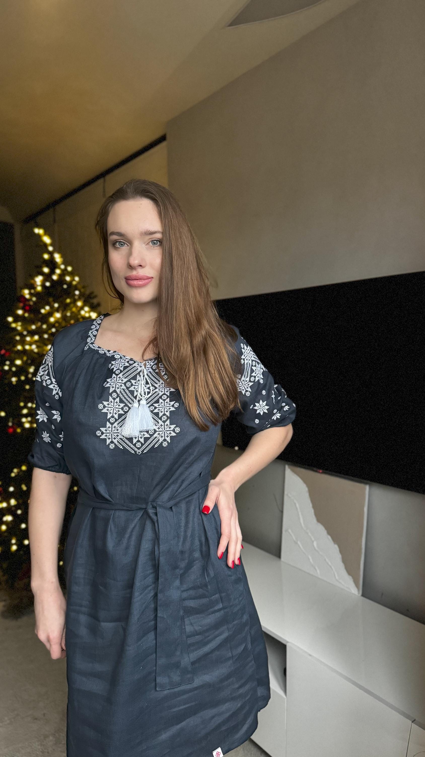 Dark blue Ukrainian vyshyvanka dress with Alatyr embroidery pattern, featuring a natural linen material and detachable belt.