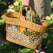 Handmade rattan-like picnic basket filled with fruits, perfect for stylish outings and shopping. Durable plastic woven design in brown.