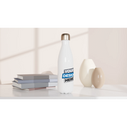 Print on demand stainless steel water bottle 17oz with customizable surface, placed on a table with books and decorative vases.