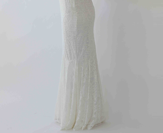 Side view of Elirelle ivory lace wedding dress showcasing intricate mermaid silhouette and elegant design.
