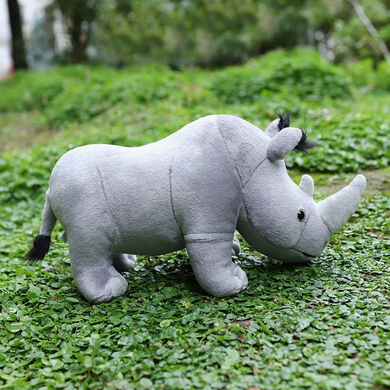 Rhino shape plush toy in a grassy outdoor setting, soft and huggable stuffed animal, perfect gift for teenagers.