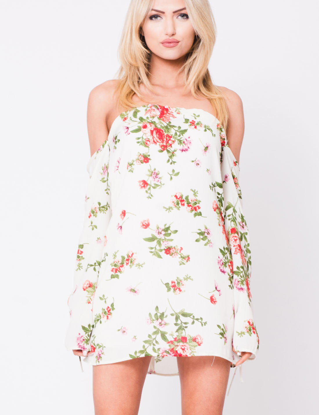 Model wearing Elvarie off-shoulder floral mini dress with long sleeves, showcasing lightweight fabric and romantic silhouette.