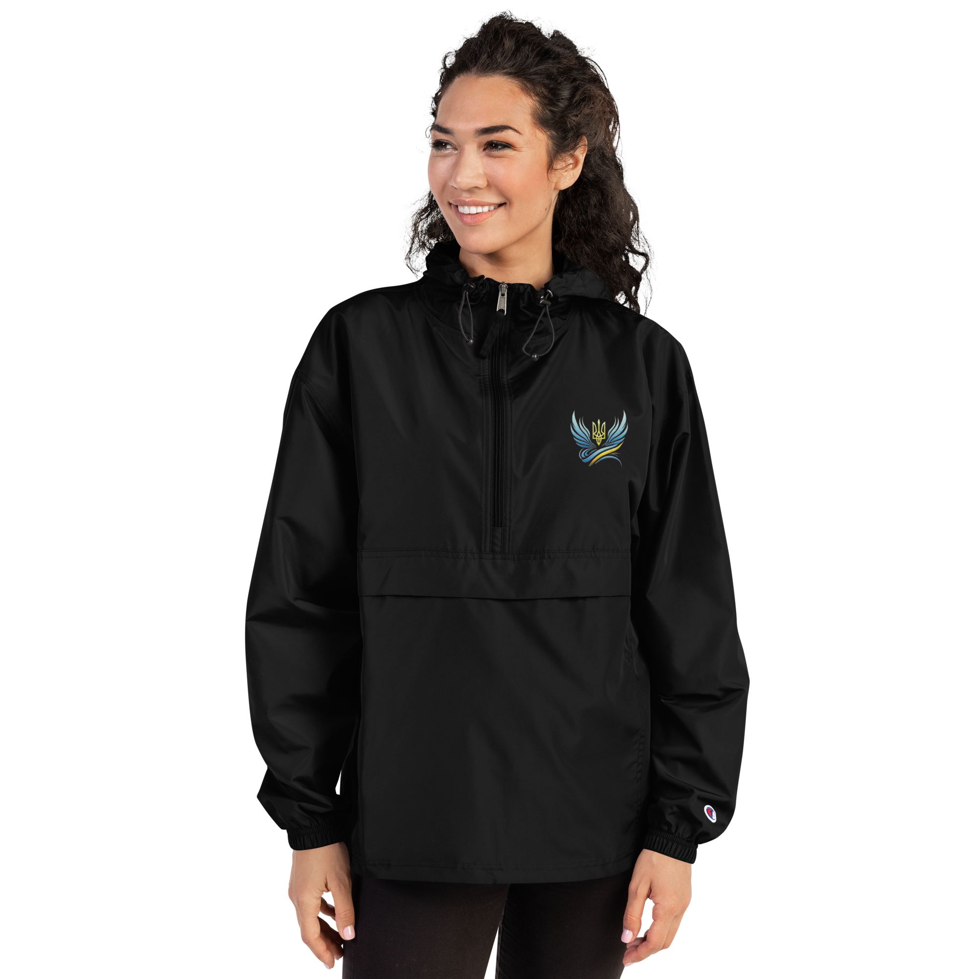 Woman wearing black embroidered Champion packable jacket from Ukrainian Vibe Trizub Collection with hood and pocket.