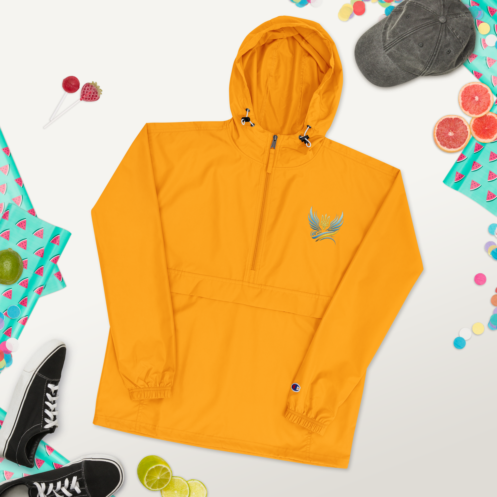 Embroidered yellow Champion packable jacket from Ukrainian Vibe Trizub Collection with hood and compact storage.