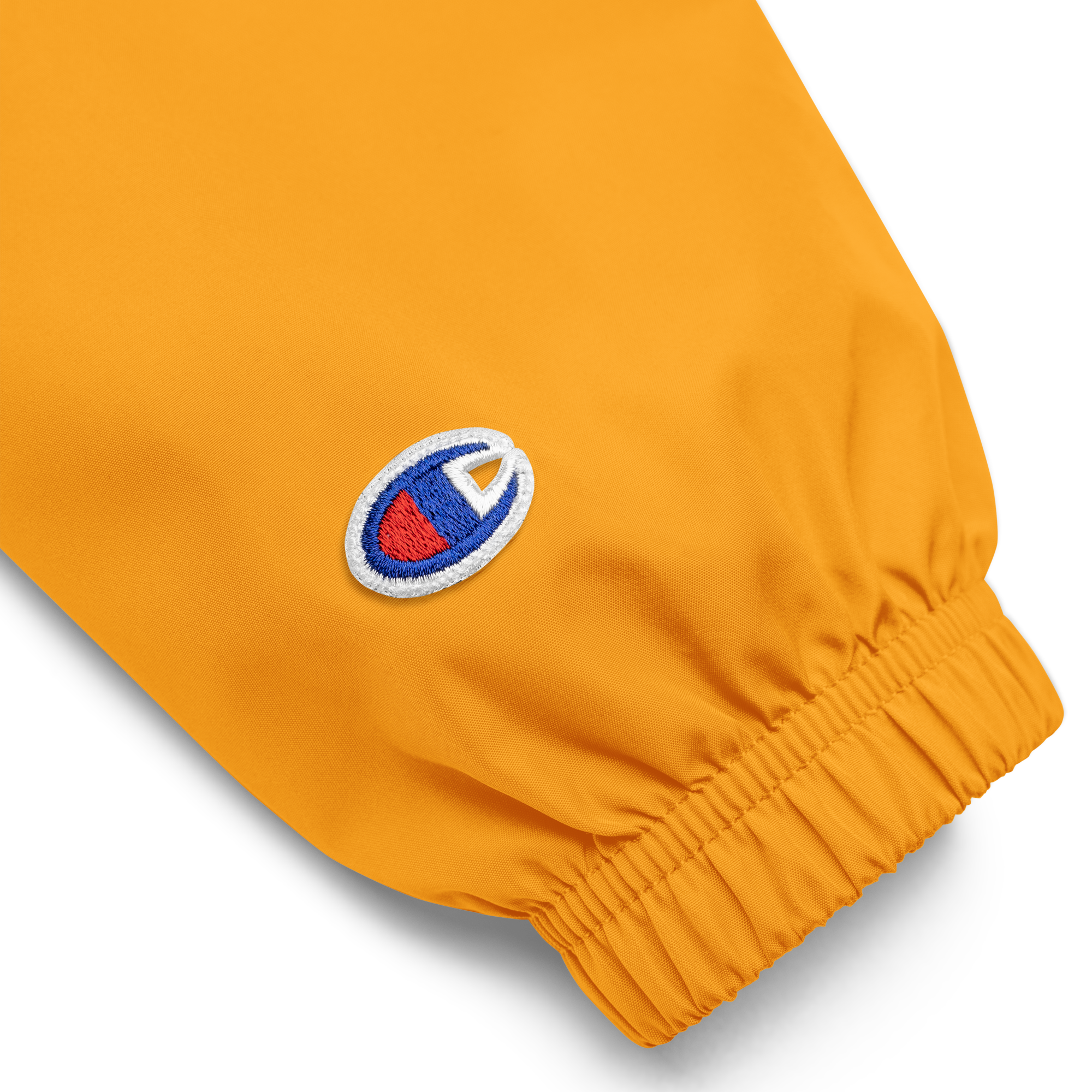 Orange embroidered sleeve detail of Ukrainian Vibe Trizub Collection Champion jacket for women, featuring durable polyester fabric.
