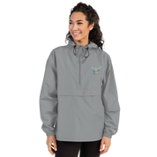 Woman wearing Ukrainian Vibe Trizub Embroidered Champion Packable Jacket, gray, with hood and kangaroo pocket.