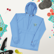 Women's embroidered blue jacket from Ukrainian Vibe Trizub Collection with hood and pockets, styled with casual accessories.