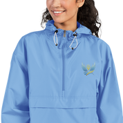 Woman wearing blue embroidered Champion packable jacket from Ukrainian Vibe Trizub Collection