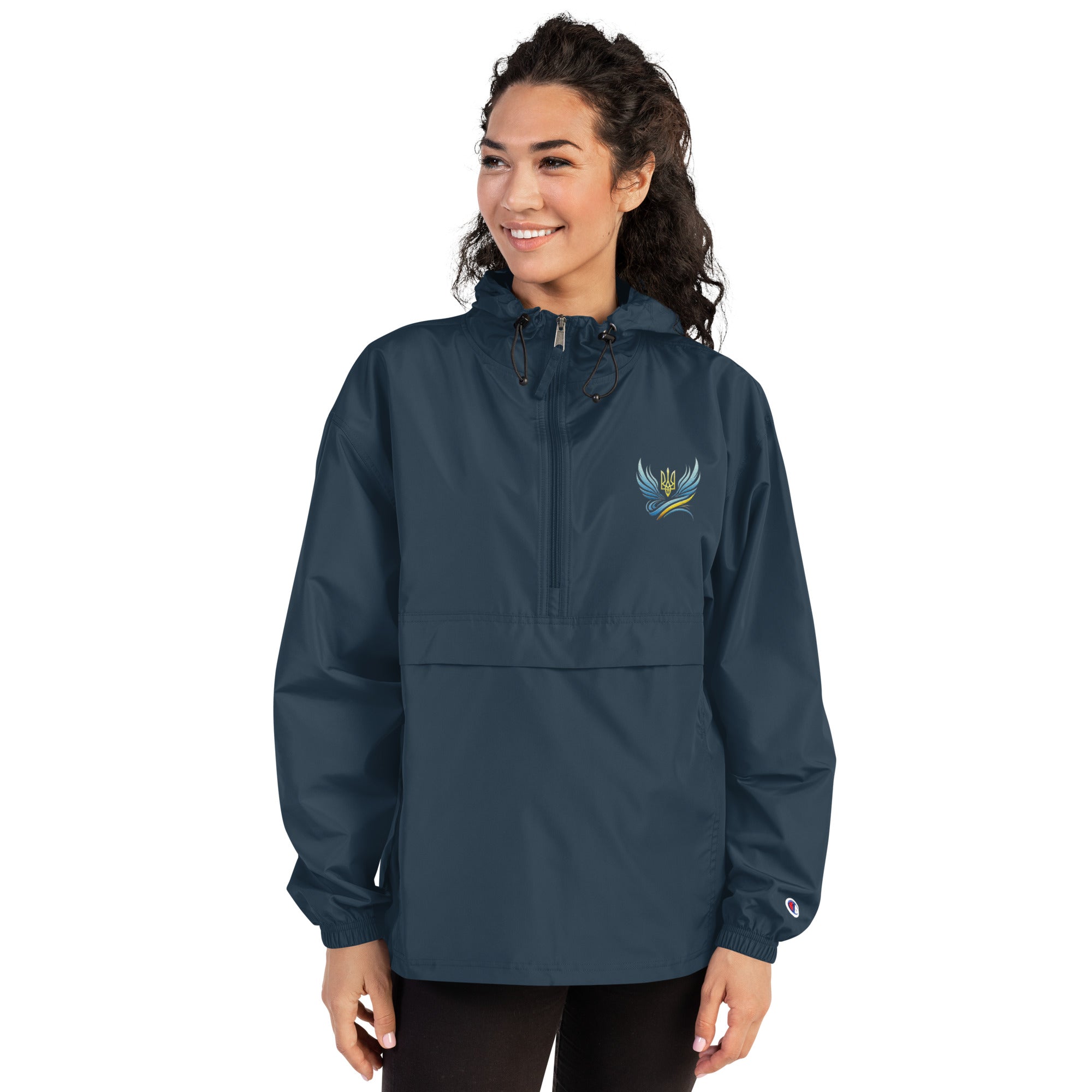 Woman wearing Ukrainian Vibe Trizub Collection Champion embroidered jacket with hood and kangaroo pocket.