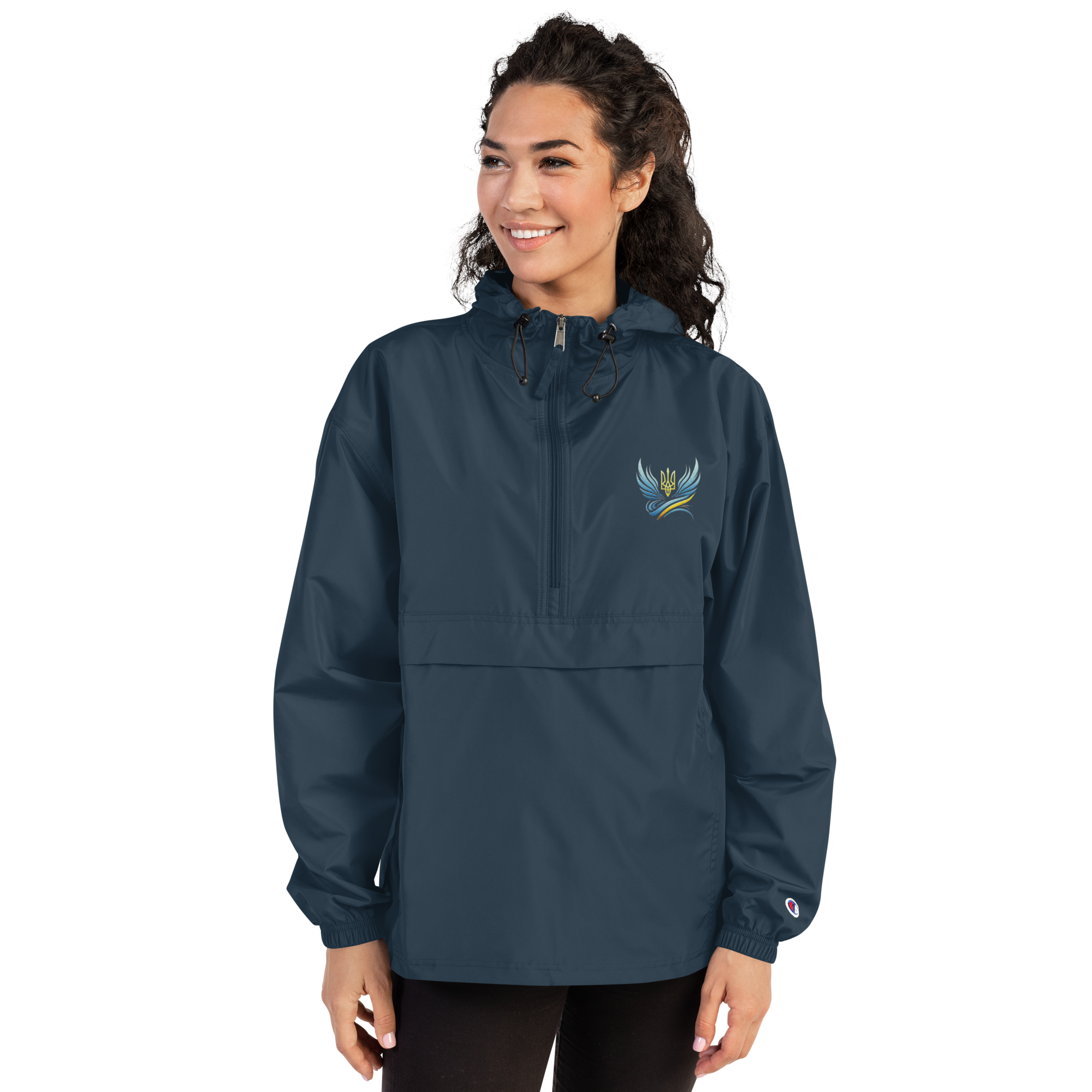 Woman wearing blue Champion packable jacket from Ukrainian Vibe Trizub Collection with embroidered Trizub design.