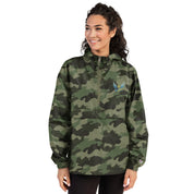 Woman in camo Ukrainian Vibe Trizub Collection embroidered Champion packable jacket, featuring a hood and kangaroo pocket.