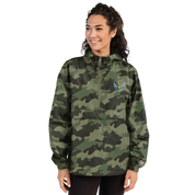 Woman wearing Ukrainian Vibe Trizub Collection embroidered camo Champion packable jacket with hood and kangaroo pocket.