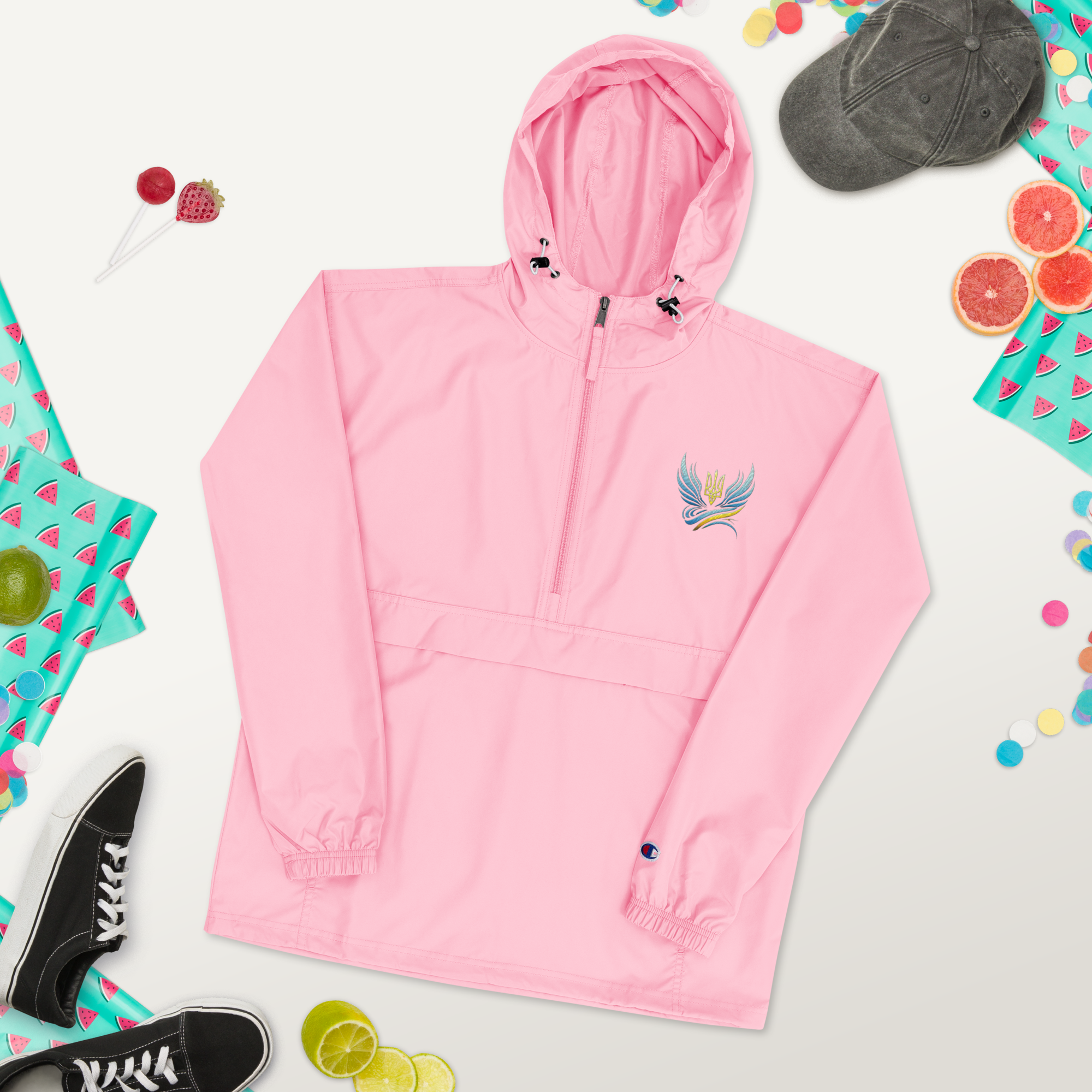 Pink embroidered Champion packable jacket from the Ukrainian Vibe Trizub Collection shown with hood and unique embroidery design.