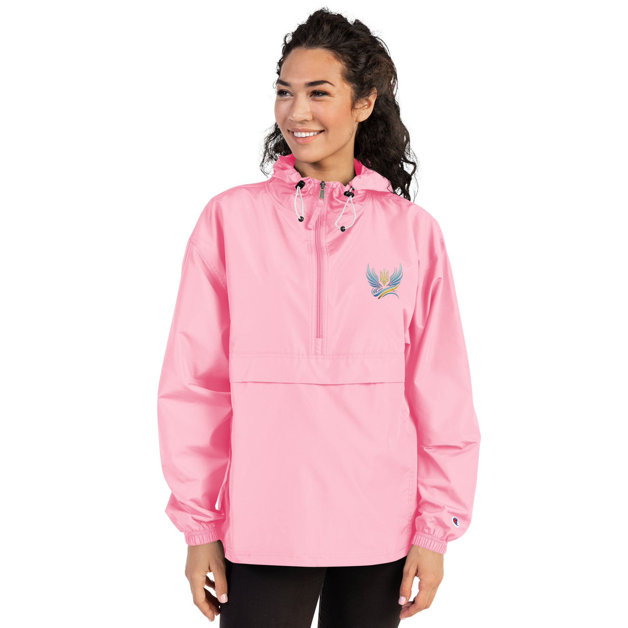 Woman wearing Ukrainian Vibe Trizub Collection pink embroidered Champion packable jacket with a hood and kangaroo pocket.
