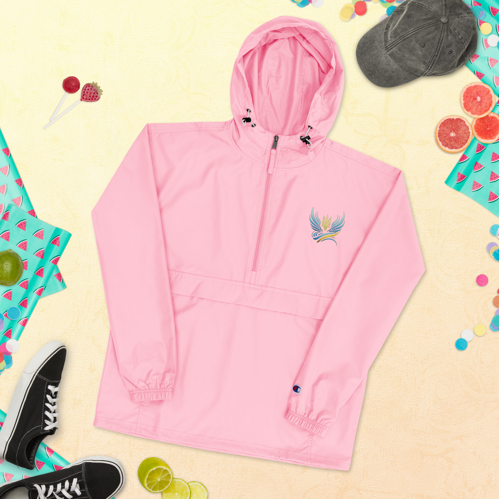 Pink embroidered Champion packable jacket from Ukrainian Vibe Trizub Collection, featuring hood and kangaroo pocket.