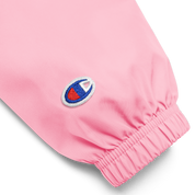 Close-up of the sleeve on pink Champion packable jacket with embroidered logo from Ukrainian Vibe Trizub Collection for women.