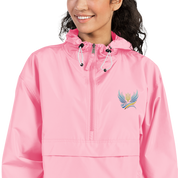 Woman wearing pink embroidered Champion packable jacket from Ukrainian Vibe Trizub Collection with hood and pouch pocket.
