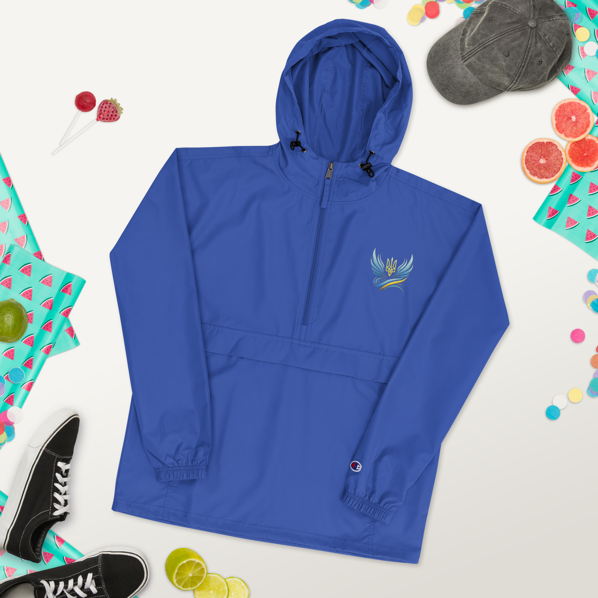 Embroidered blue packable jacket from Ukrainian Vibe Trizub Collection, featuring a hood and front pocket, designed for women.