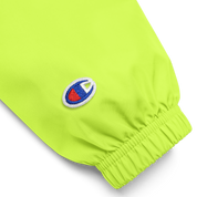 Close-up of embroidered sleeve detail on the Champion packable jacket from the Ukrainian Vibe Trizub Collection, in bright green.