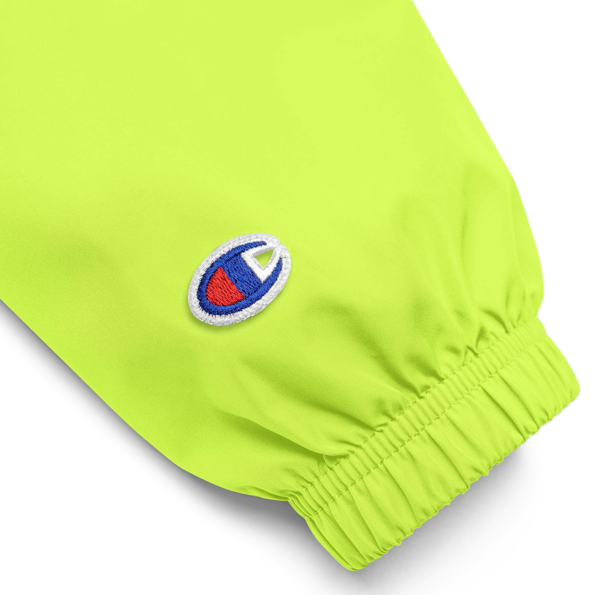 Close-up of embroidered sleeve detail on the Champion packable jacket from the Ukrainian Vibe Trizub Collection, in bright green.