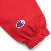 Close-up of embroidered logo on sleeve of red Champion packable jacket from the Ukrainian Vibe Trizub Collection.
