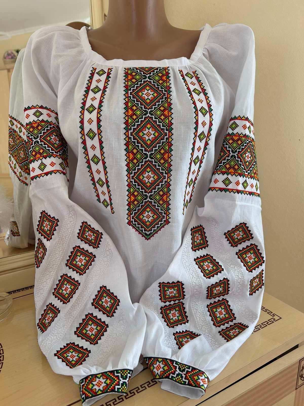 Traditional Ukrainian embroidered linen vyshyvanka blouse with authentic cross-stitch patterns, handmade by Carpathian artisans.