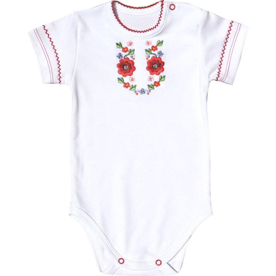 White embroidered baby bodysuit in Ukrainian Vyshyvanka style with red floral motifs for girls.