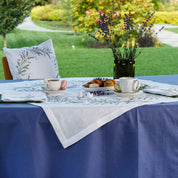 Embroidered linen tablecloth with lavender design on a dining table, showcasing Ukrainian folk art, perfect for special occasions.