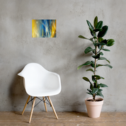 Modern abstract Ukrainian flag poster with Tryzub emblem on wall above white chair and green plant.